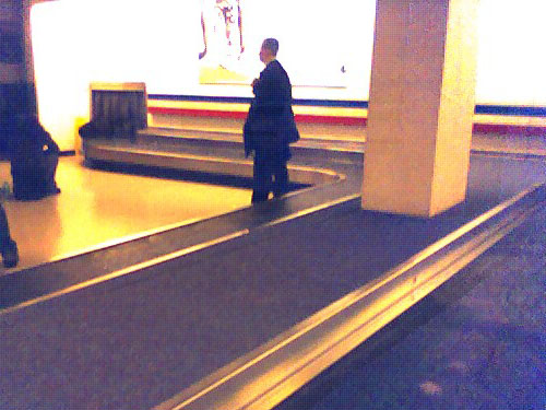 Guy Behind waiting for his luggage